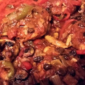 Mediterranean chicken up close in the pan after coming out of the oven.